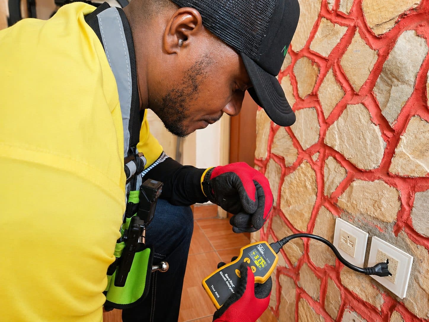 HINL inspector testing electrical outlet with circuit analyser